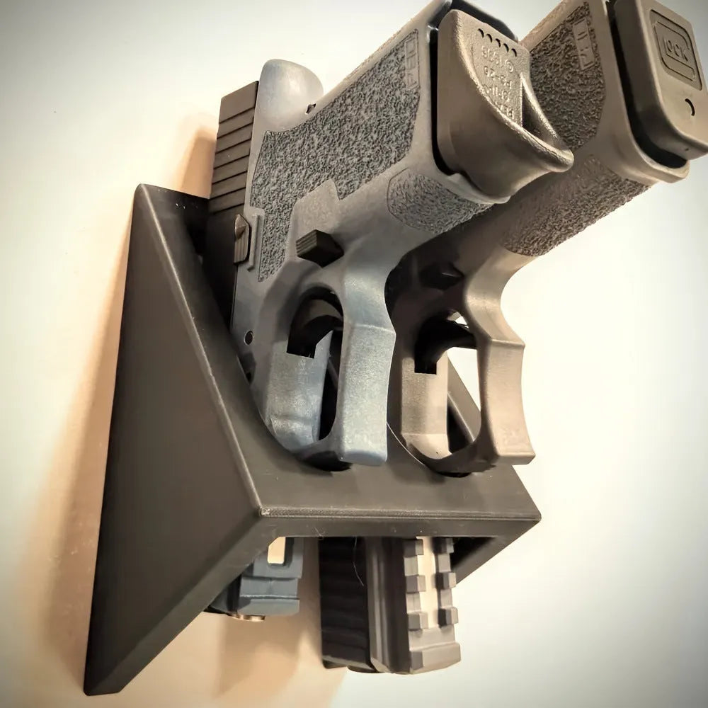 Black plastic pistol stand with punk-style detailing measuring 10.85 cm