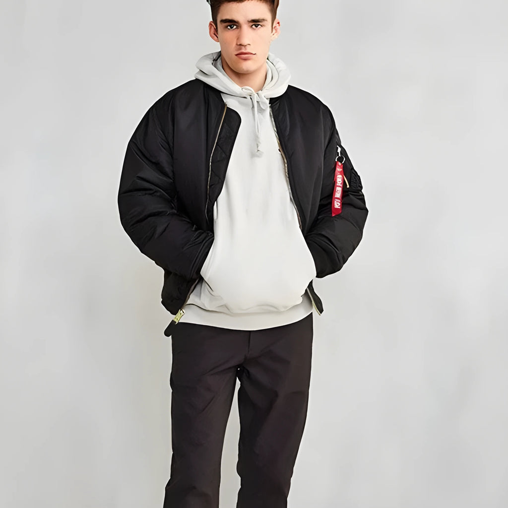 Men's army green American workwear style cotton-padded nylon jacket with a loose fit on a hanger.