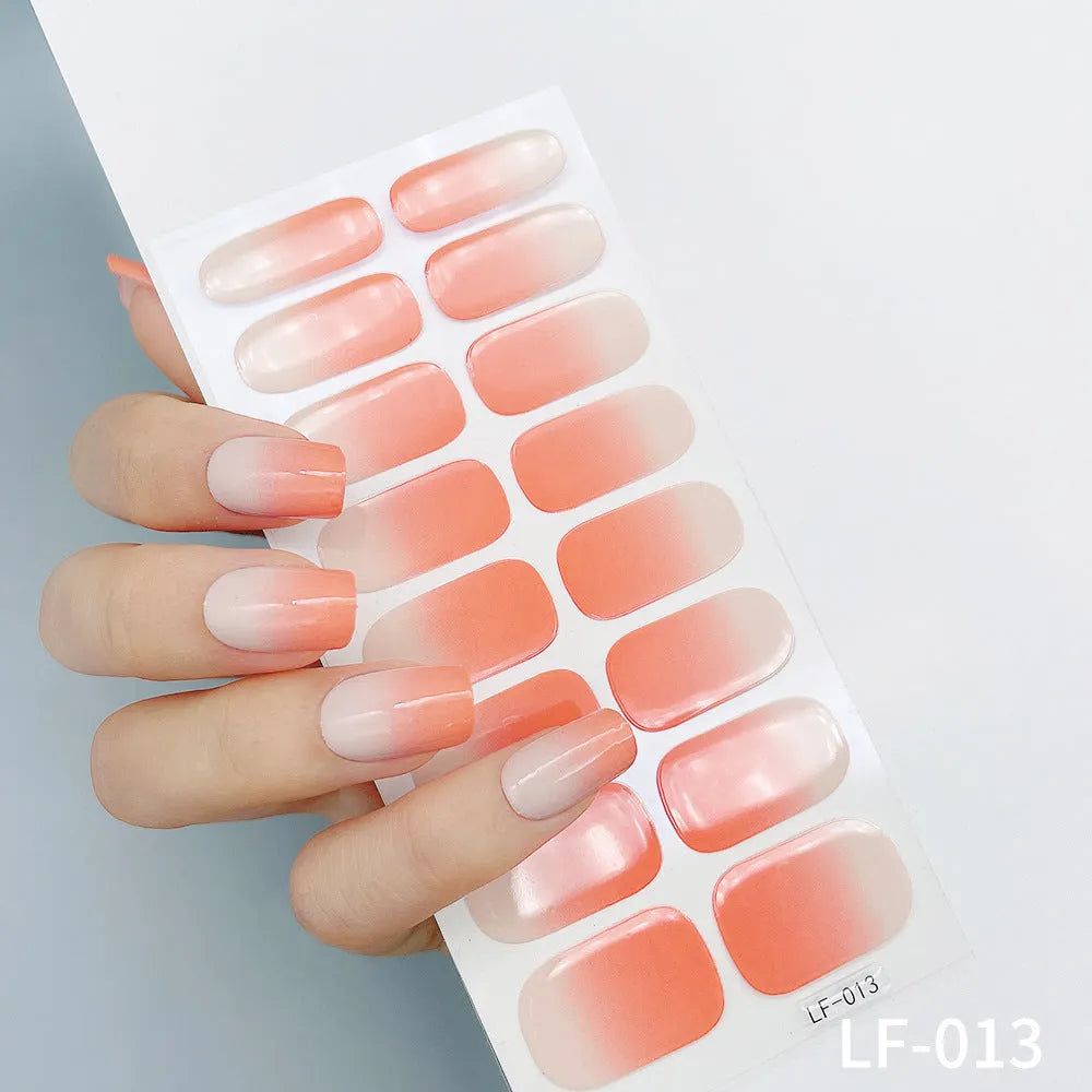 Pack of 16 solid colour full nail art stickers showing floral, heart, cartoon, and geometric pattern designs.