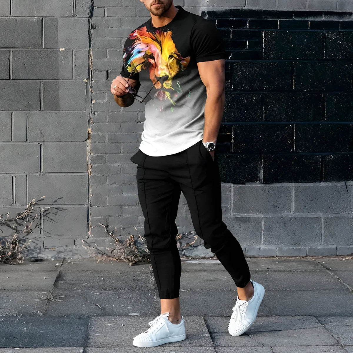 Man wearing a short-sleeved printed pullover and matching trousers from a lightweight polyester sport suit set.