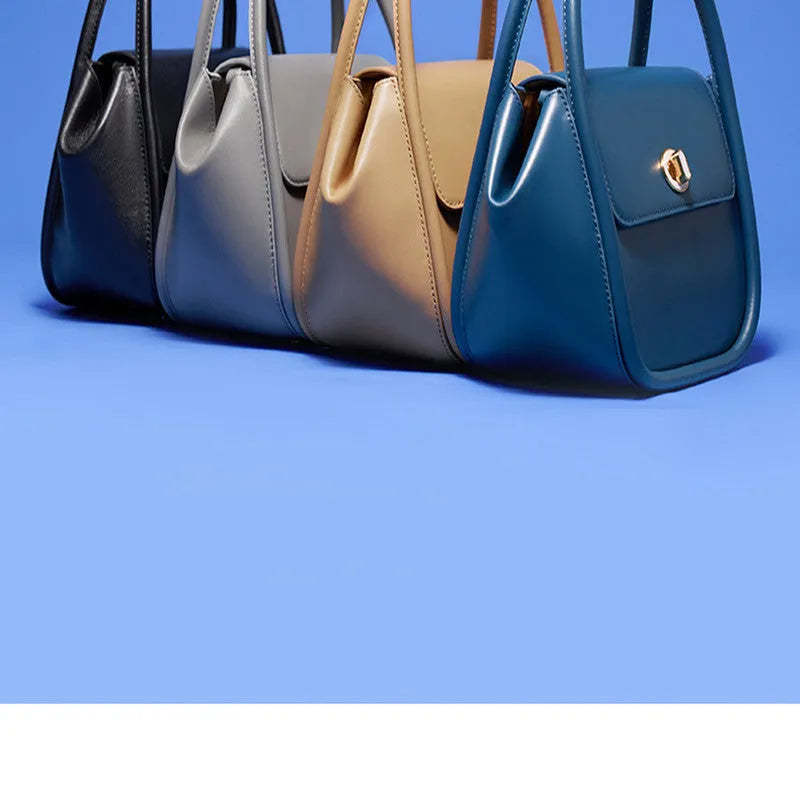 Women's leather cross-body wing bag with buckle closure in four colour options
