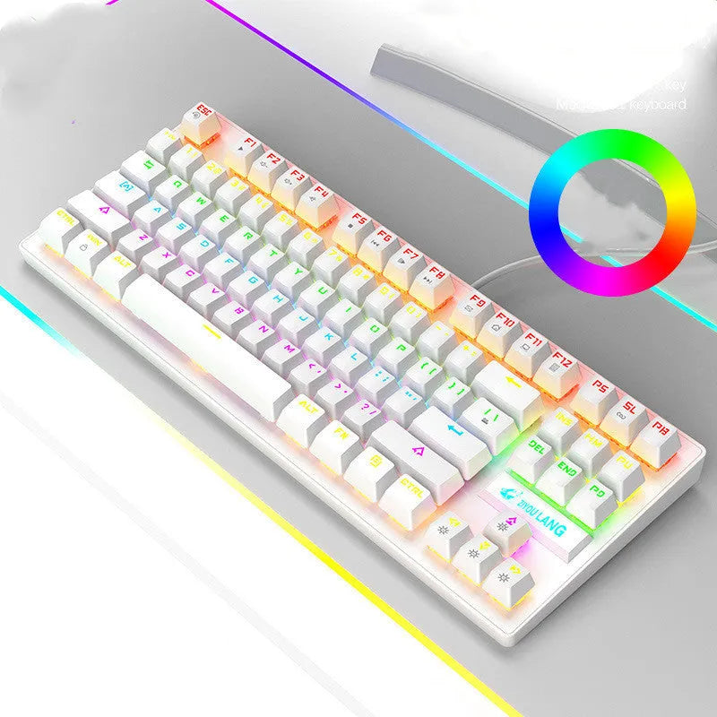 Compact mechanical gaming keyboard with RGB lighting next to laptop