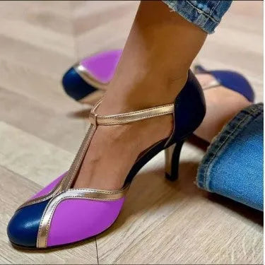 Women's blue and pink round toe stiletto high heel pump with button fastening.