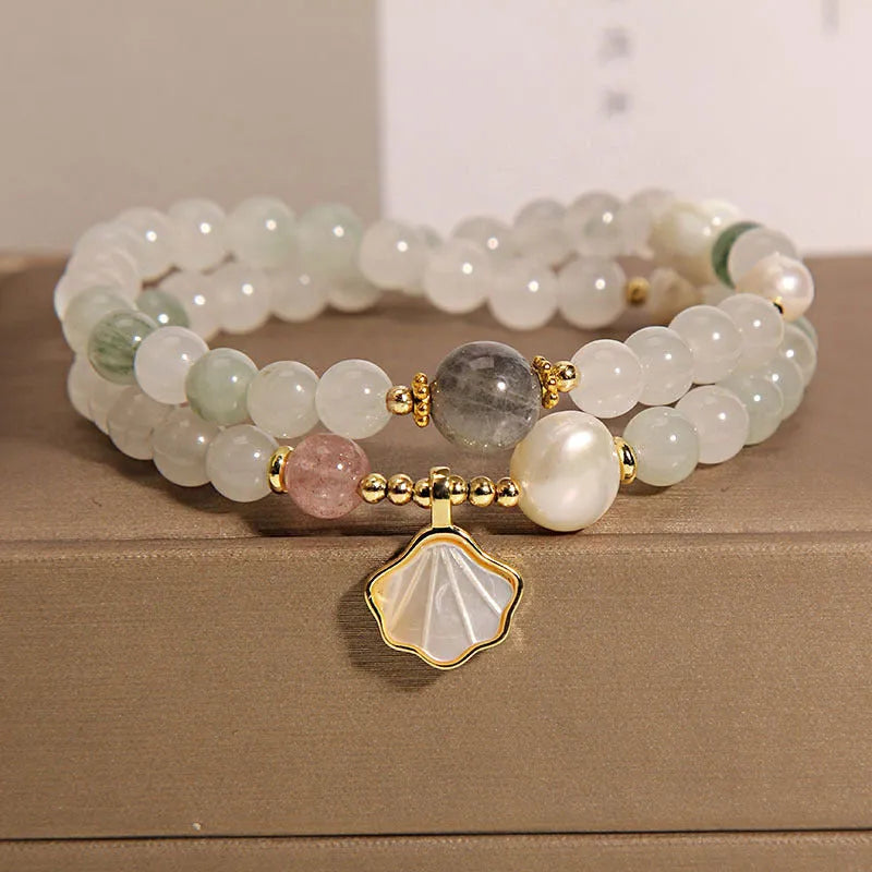 Emerald green crystal bracelet with ginkgo leaf pendant and gold-plated rhinestone details