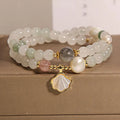 Emerald green crystal bracelet with ginkgo leaf pendant and gold-plated rhinestone details