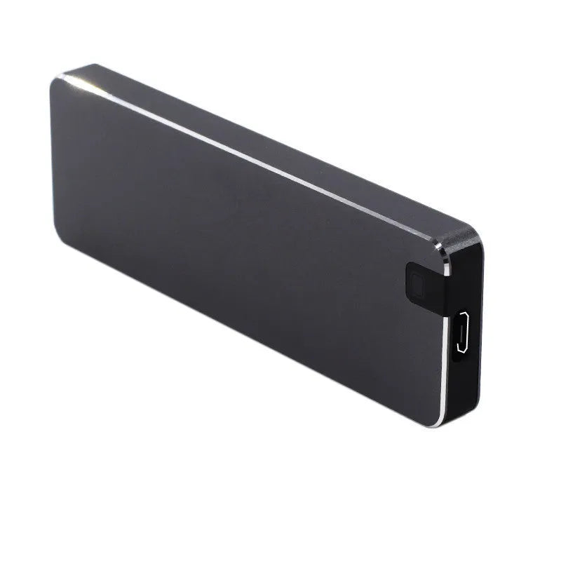 Compact silver portable solid state hard drive with USB cable on a dark surface