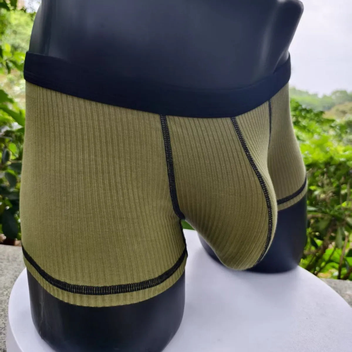 Men's solid colour boxers showing hip lifting and body shaping design in breathable fibre fabric