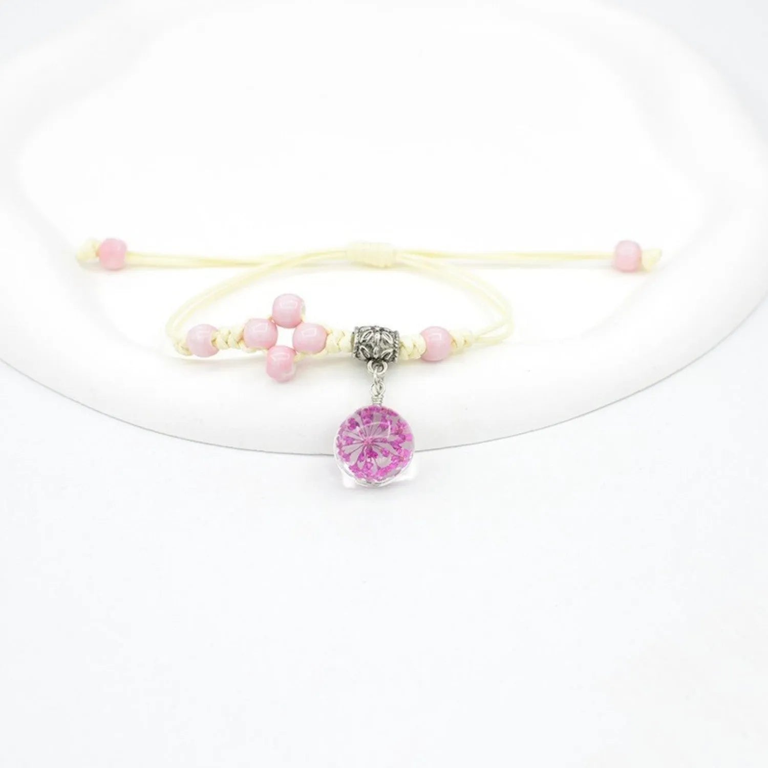 Women's hand-woven glass bracelet with large 1.4cm beads containing dried flowers, shown in blue colour option