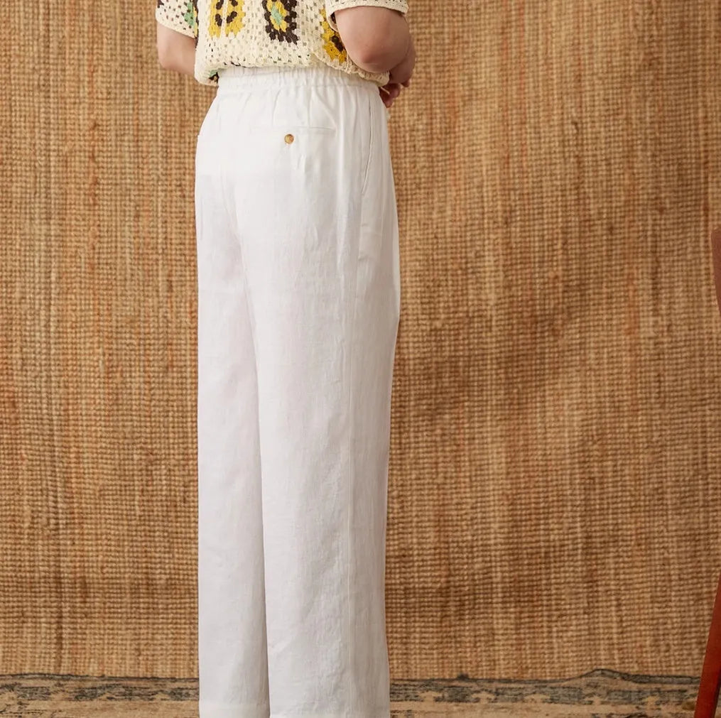 Linen straight-leg trousers in greige with an elasticated high waistband on a neutral background.