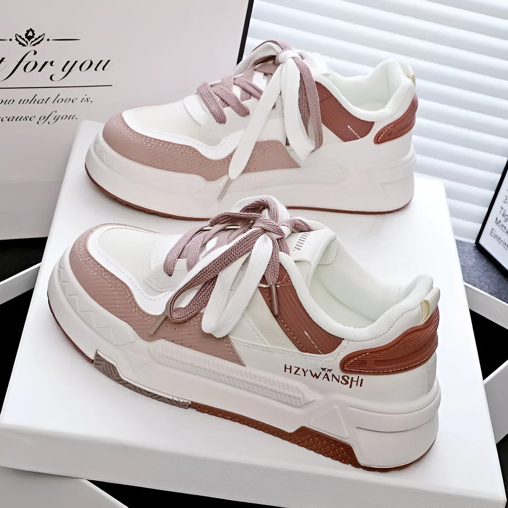Children's beige platform shoes with front lace-up closure and an overfoot cross-strap on a thick rubber sole.
