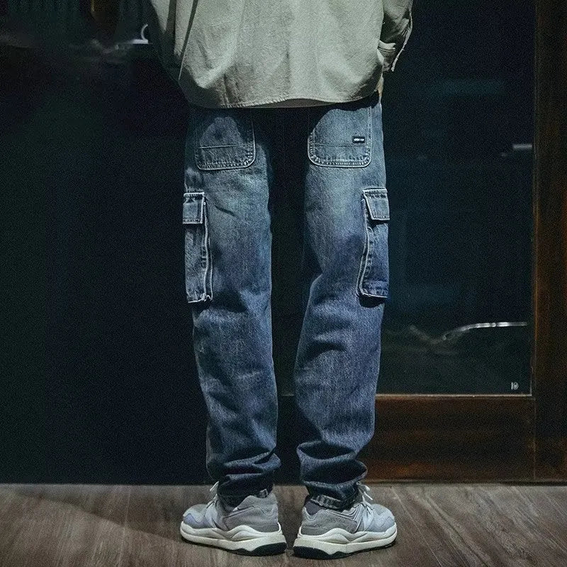 Man wearing blue loose straight-leg retro style stretch denim pants.