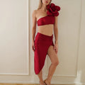 Women's solid colour bikini with three-dimensional floral pattern on a mannequin, shown in magenta.