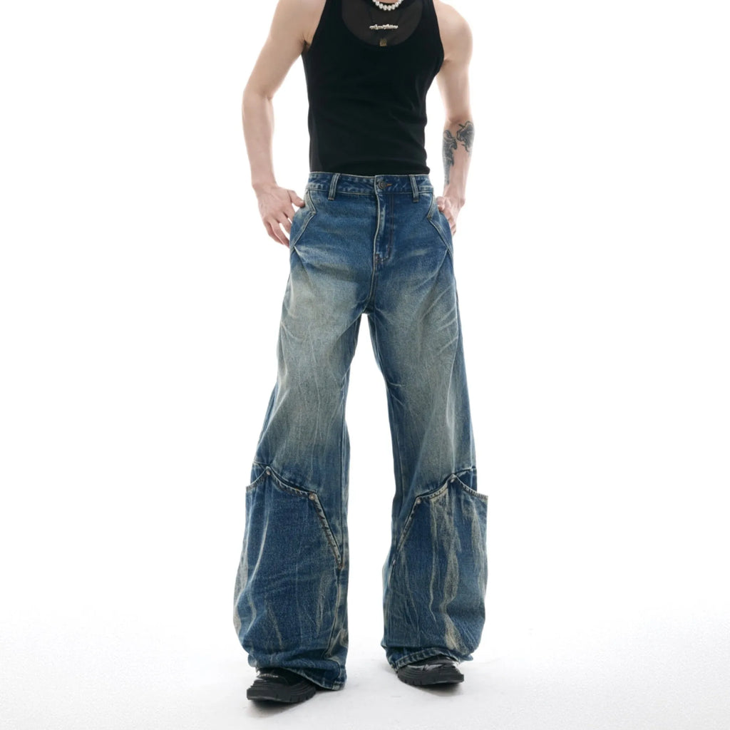 Man wearing verdant blue retro washed burst pattern jeans with a curved knife cut and loose fit.