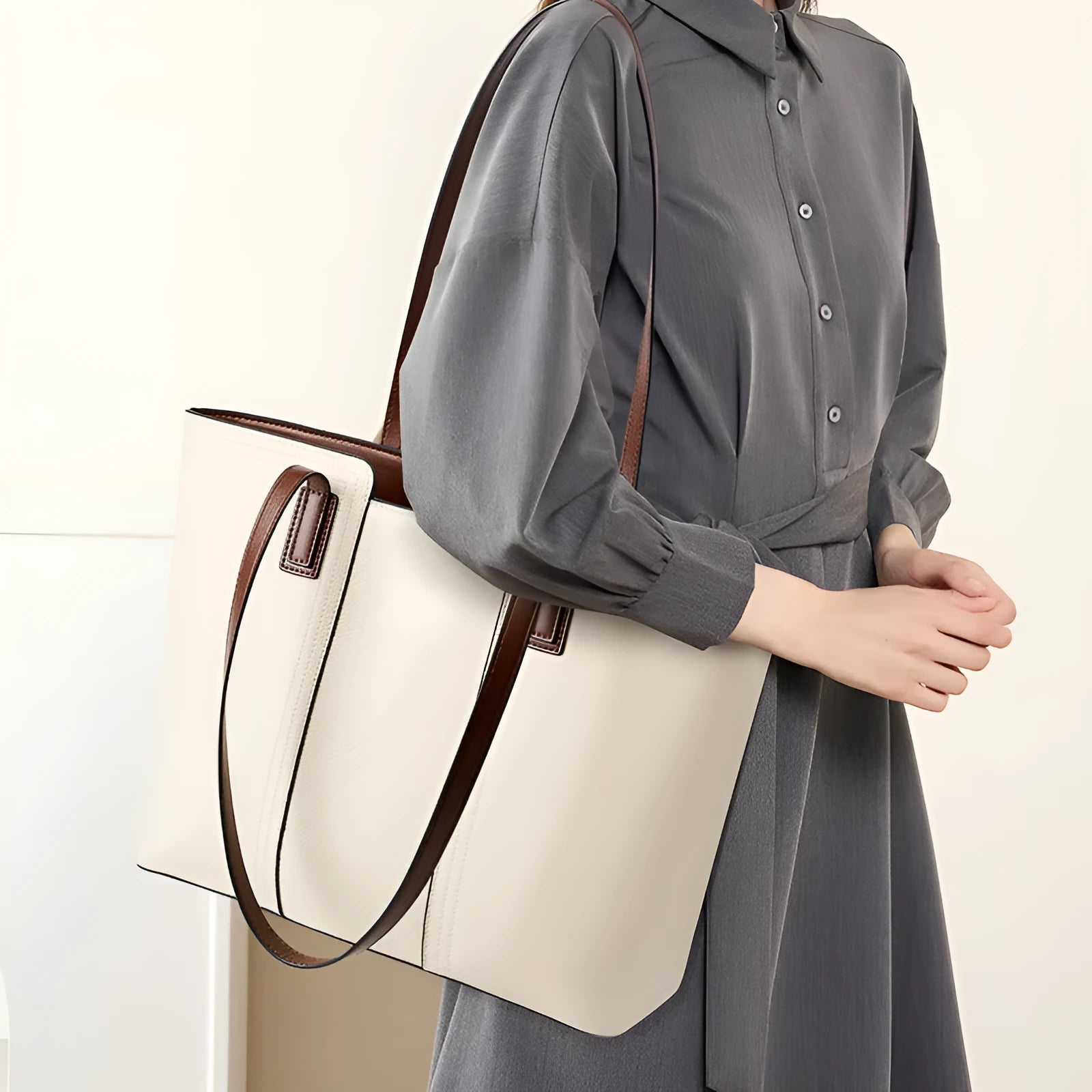 Women's black genuine leather horizontal square shoulder bag with crossbody strap showing internal organiser compartments.