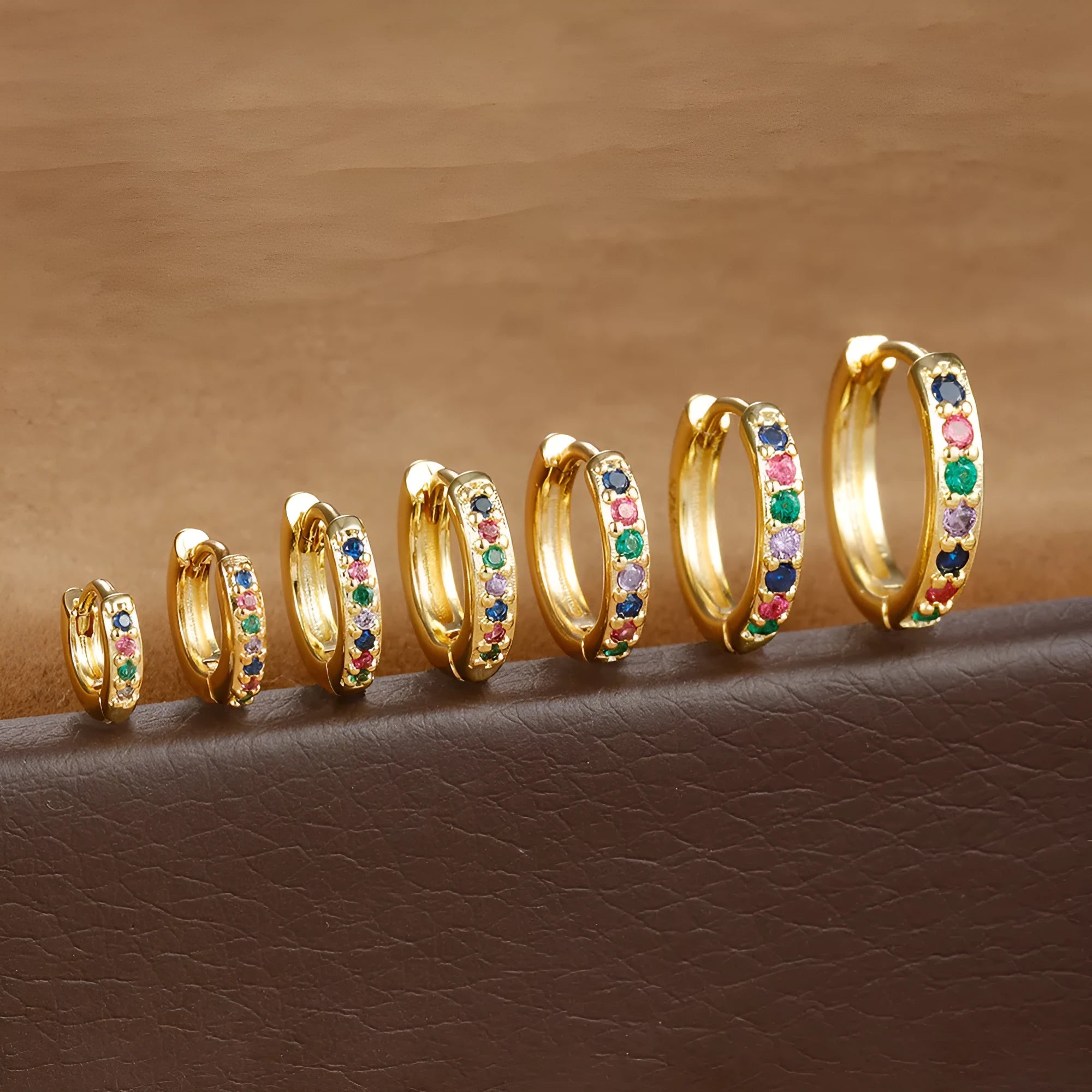 Set of three pairs of round zircon stud earrings showing gold colour, rose gold colour, and silver colour finishes.
