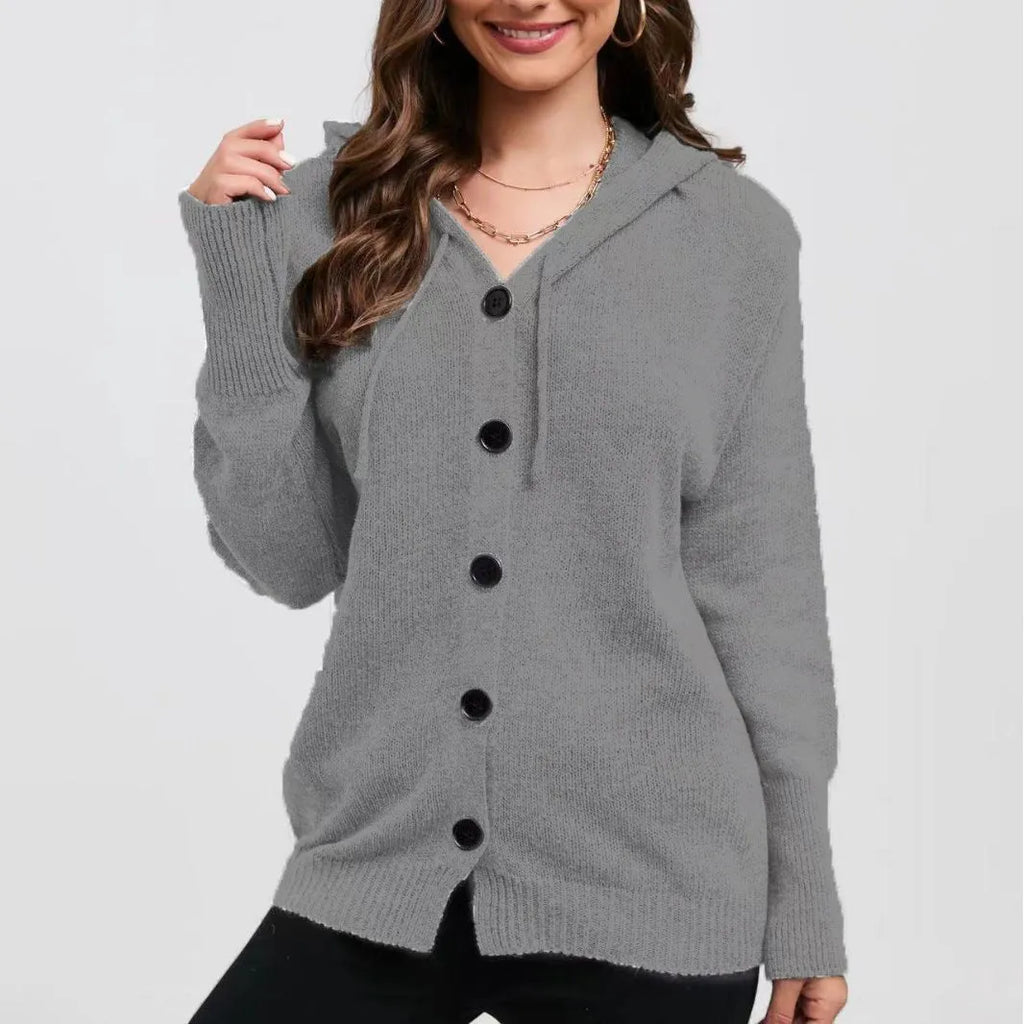 Woman wearing a loose-fit, thick cotton hooded cardigan sweater in a solid colour.