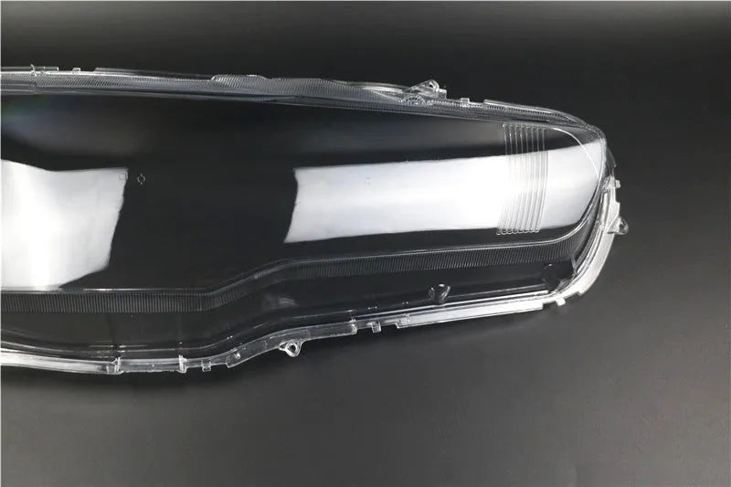 Transparent plastic headlight housing cover for car lighting replacement measuring 50x30x20mm