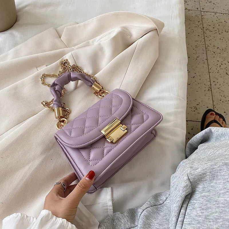Small purple rhombus-shaped square shoulder bag with a long crossbody strap
