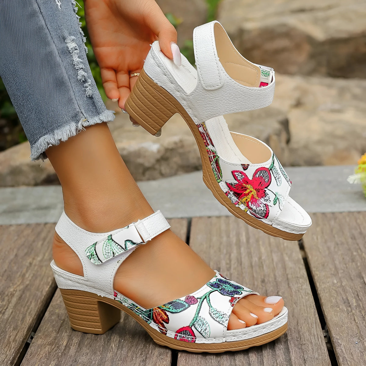 White women's high heel sandals with a velcro buckle strap and rubber sole.