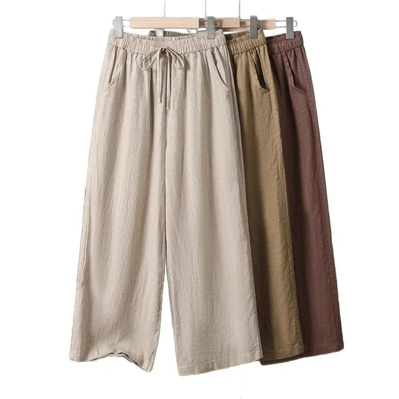 Women's apricot straight-leg casual trousers with a drawstring elasticated waist laid flat.