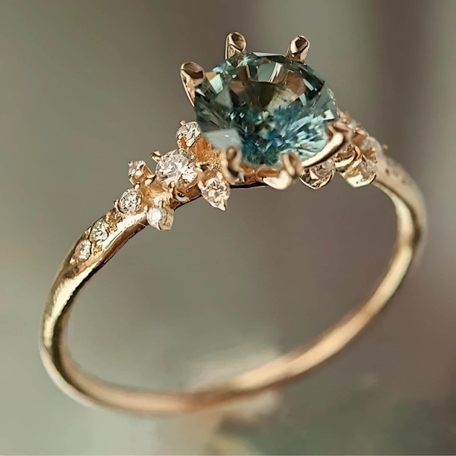 Gold plated geometric ring with claw setting holding inlaid zircon stones, shown in size options 6 to 10.