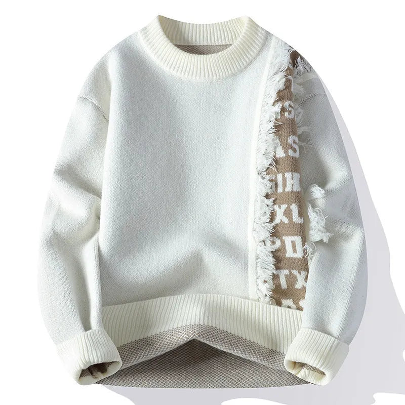 Man wearing a loose-fit grey knitted long sleeve pullover with a ribbed hemline.