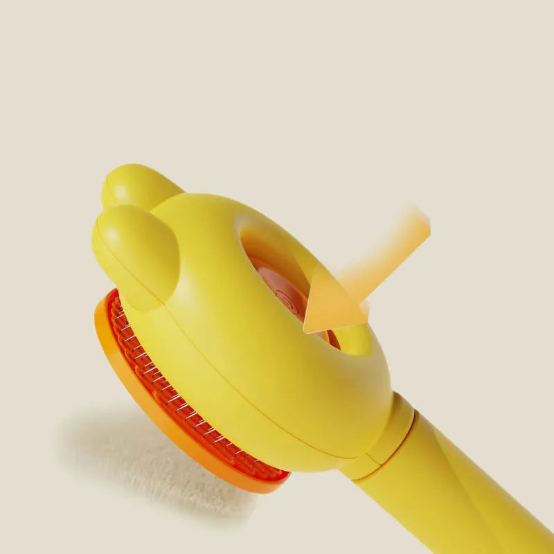 Self-cleaning pet brush with release button showing stainless steel comb teeth and coloured handle