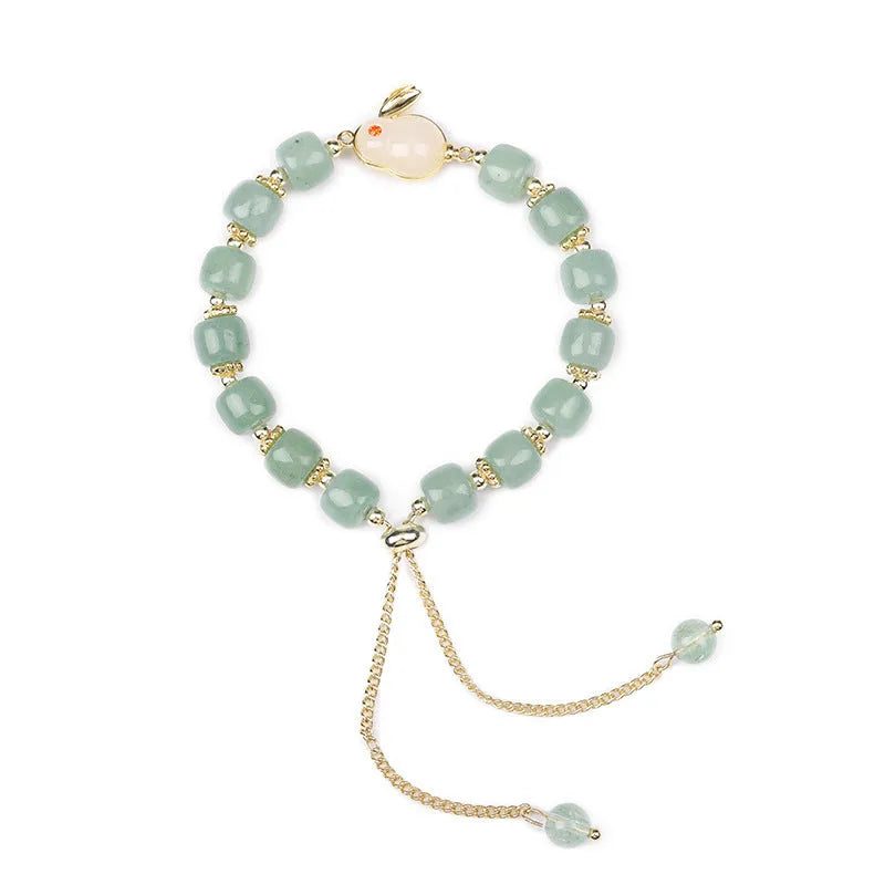 Rabbit motif bracelet with green aventurine and strawberry quartz stones in gold and copper setting