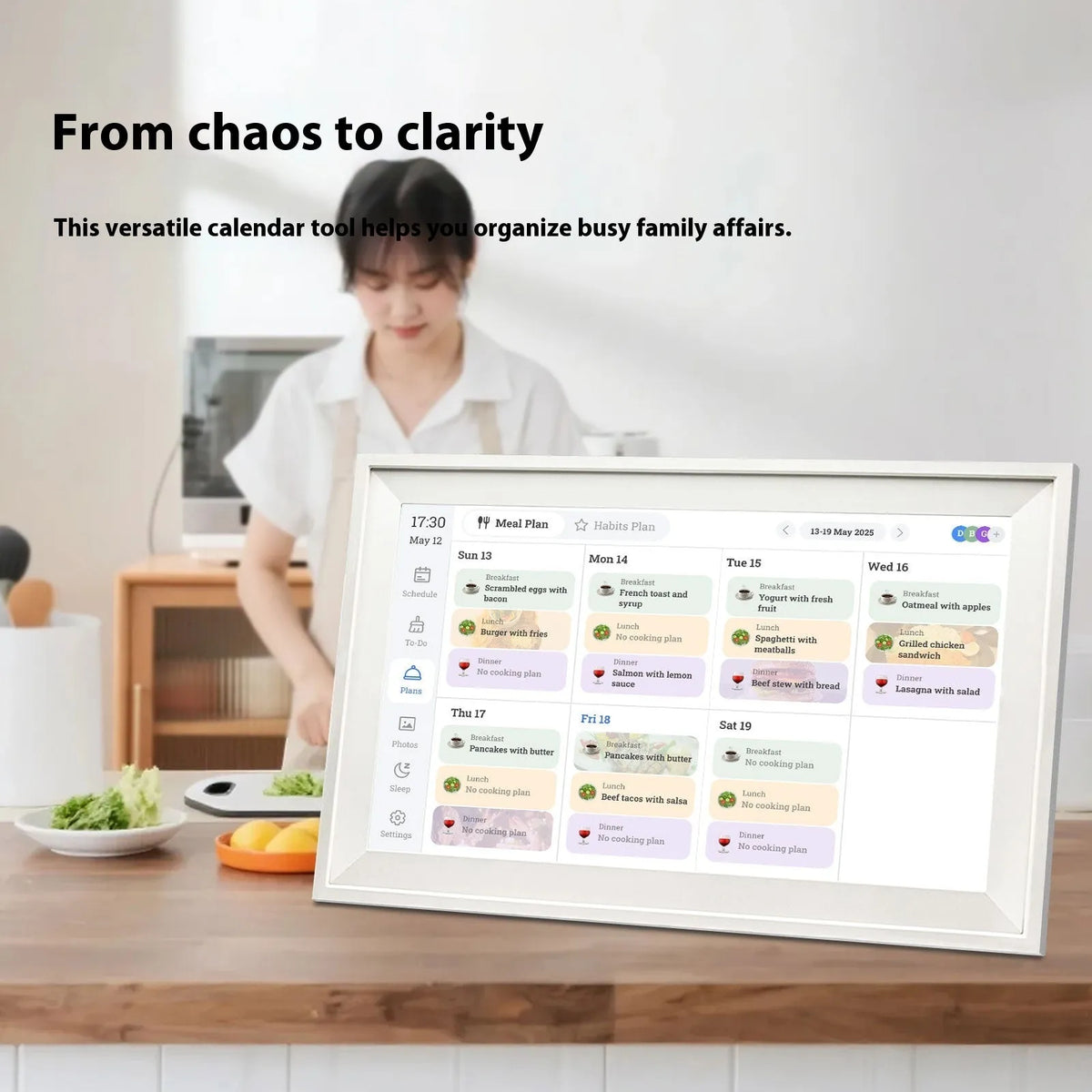 White 15.6 inch smart digital photo frame showing family photographs on Full HD display