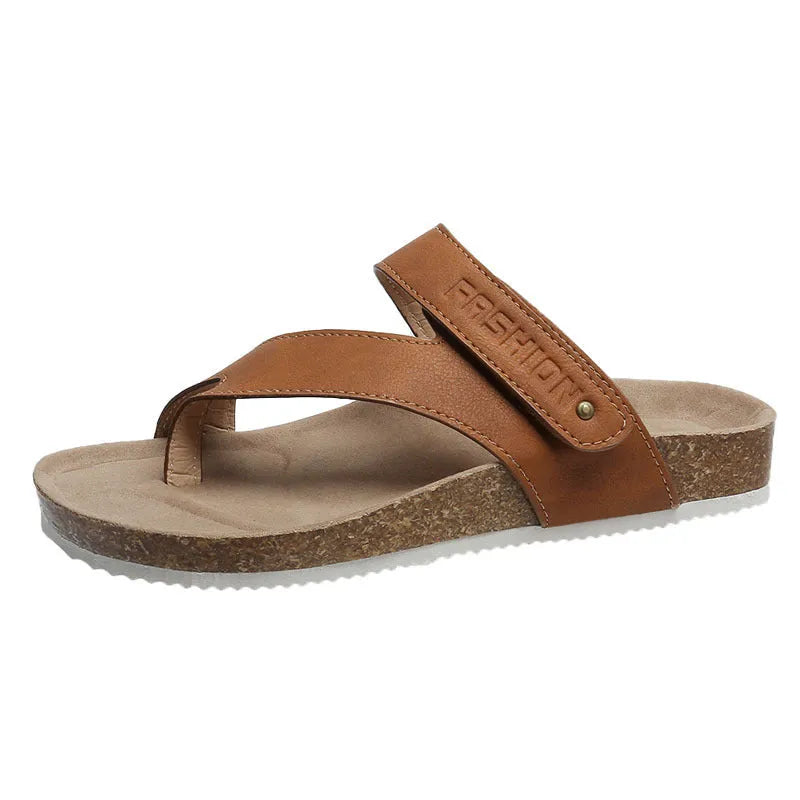 Flat toe ring flip-flops in blue with a thick foam sole on a wooden floor.
