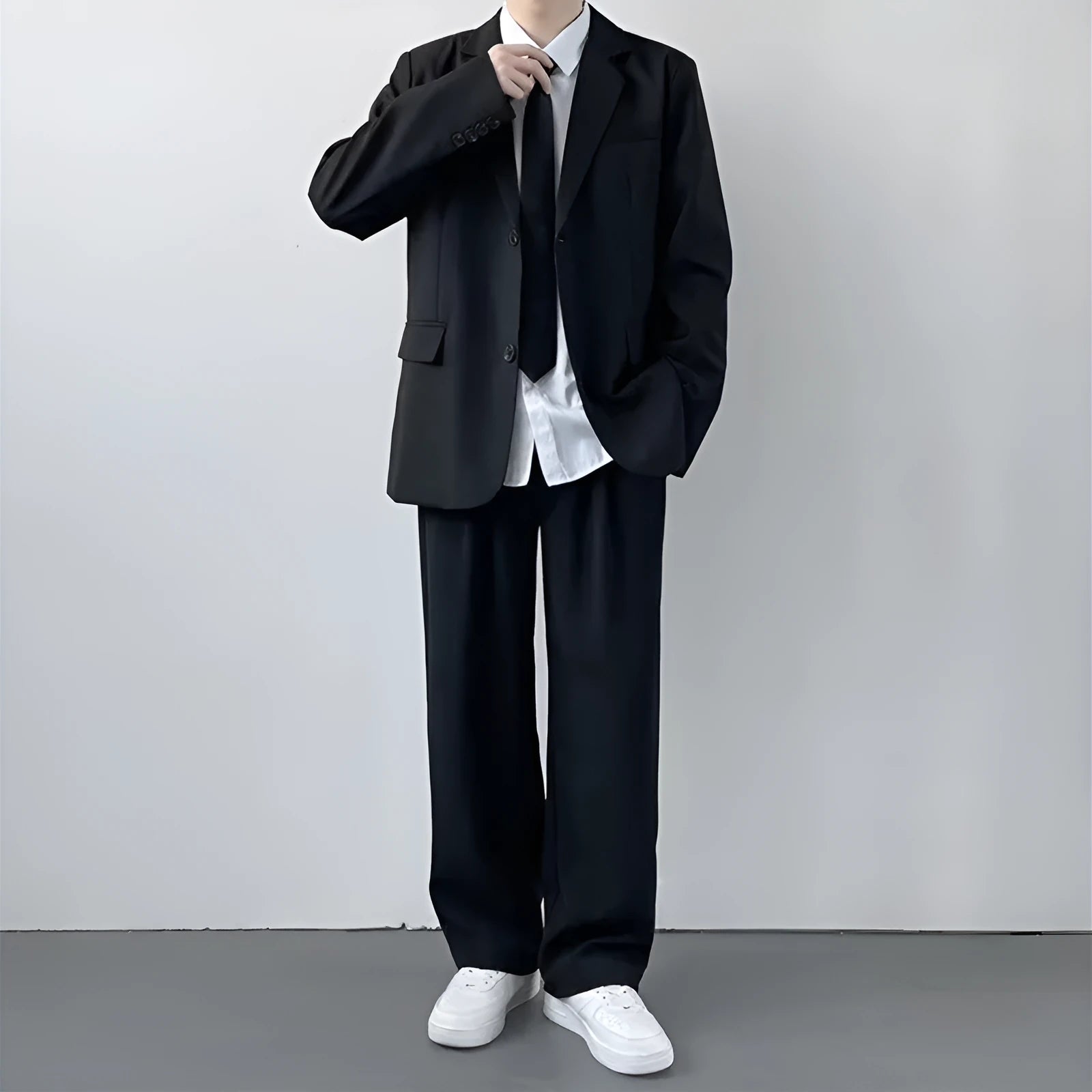 Plus size man wearing a navy college style suit jacket and trousers with a white shirt and blue tie.
