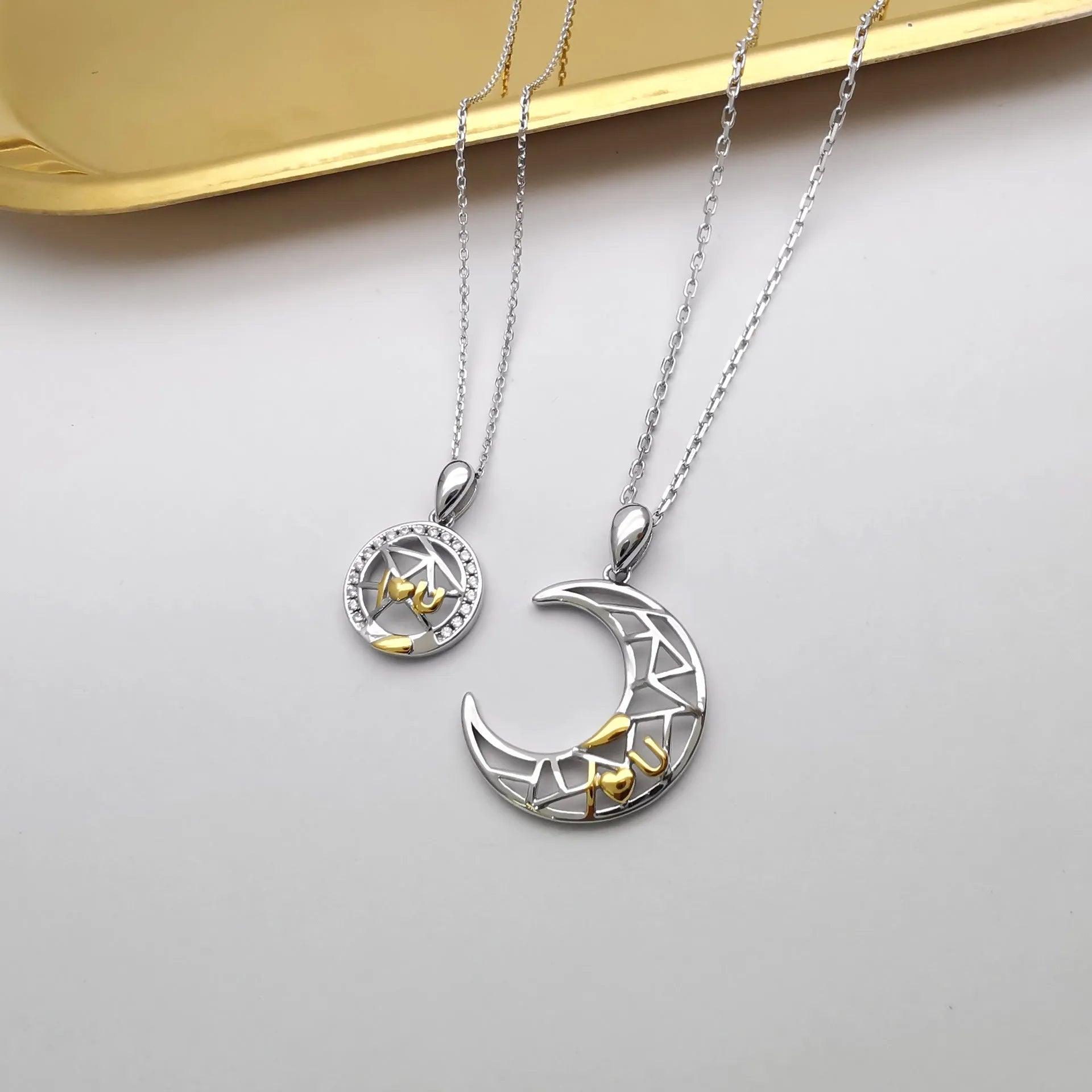 Sun Moon Tooth couple necklace set showing male and female copper pendants on cross chains