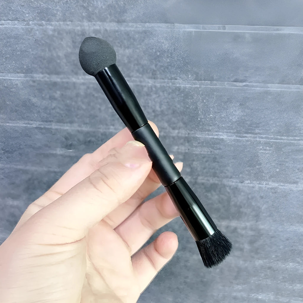Black concealer brush with wooden handle and sponge stick tip for under-eye application