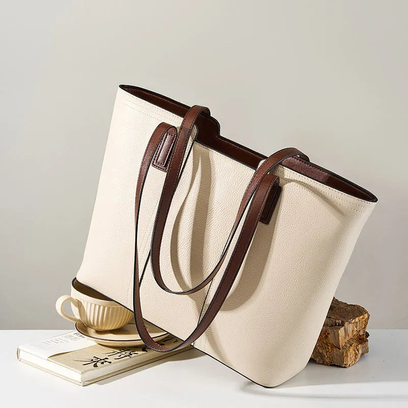 Women's black genuine leather horizontal square shoulder bag with crossbody strap showing internal organiser compartments.