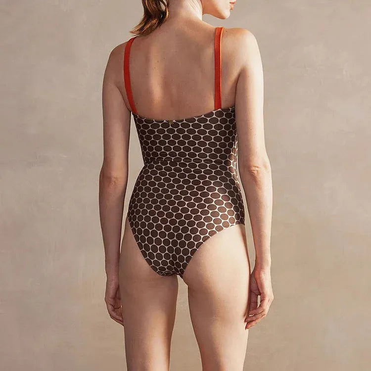 Women's printed dot pattern one-piece swimsuit with matching wrap skirt set on a mannequin
