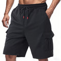 Man wearing light grey loose-fit cargo shorts made from textured towel fabric with multiple pockets.