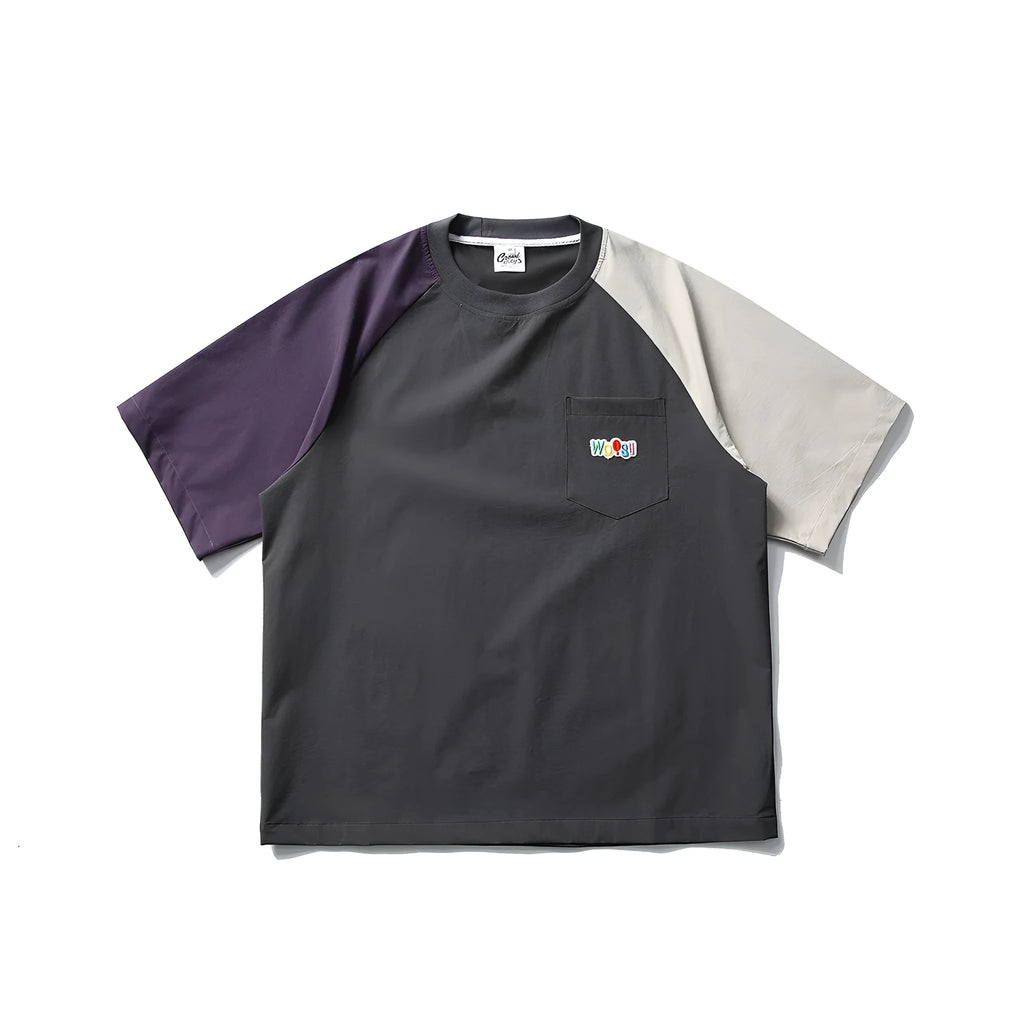 Dark grey men's loose fit T-shirt with contrast colour raglan sleeves on a hanger.