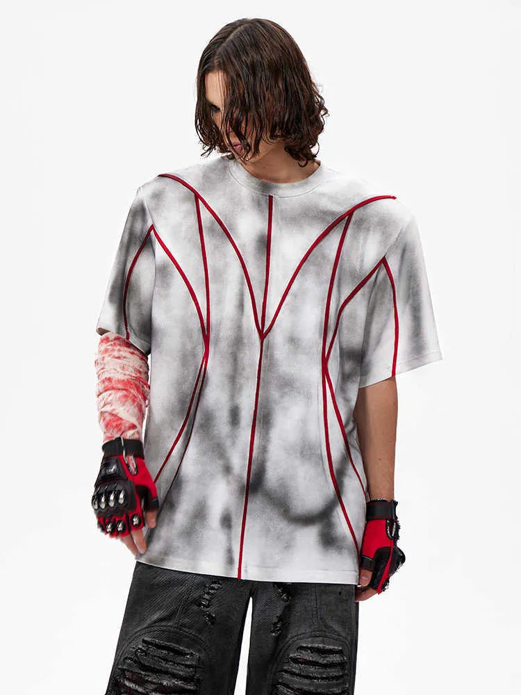 Women's grey padded shoulder t-shirt with textured patchwork design on the front.