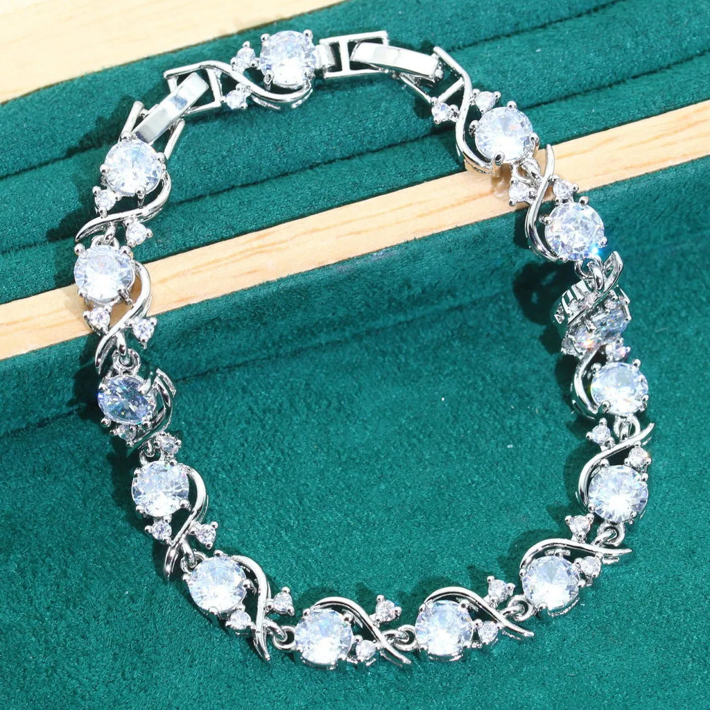 Bridal four-piece zircon jewellery set showing necklace, bracelet, earrings, and ring in alloy with water wave chain.