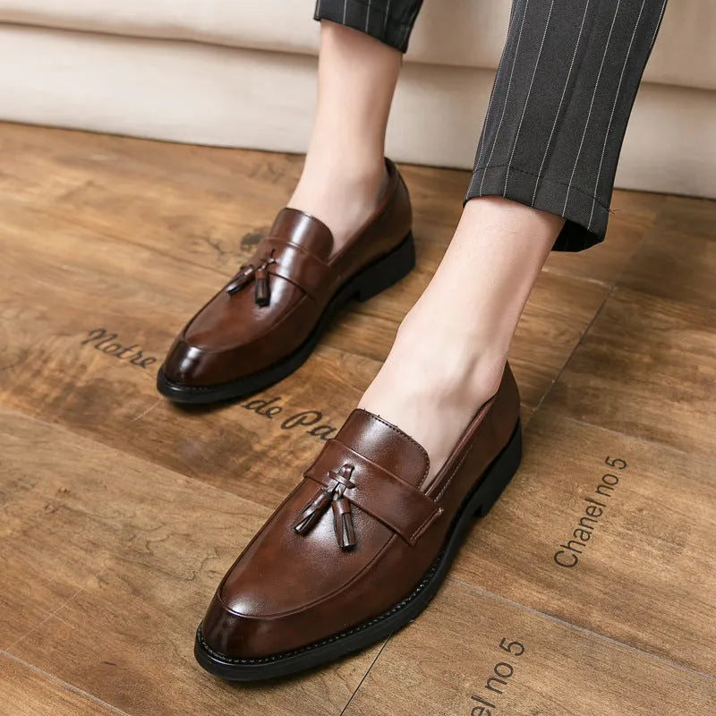 Men's black slip-on business casual shoes with tassel detail and rubber soles