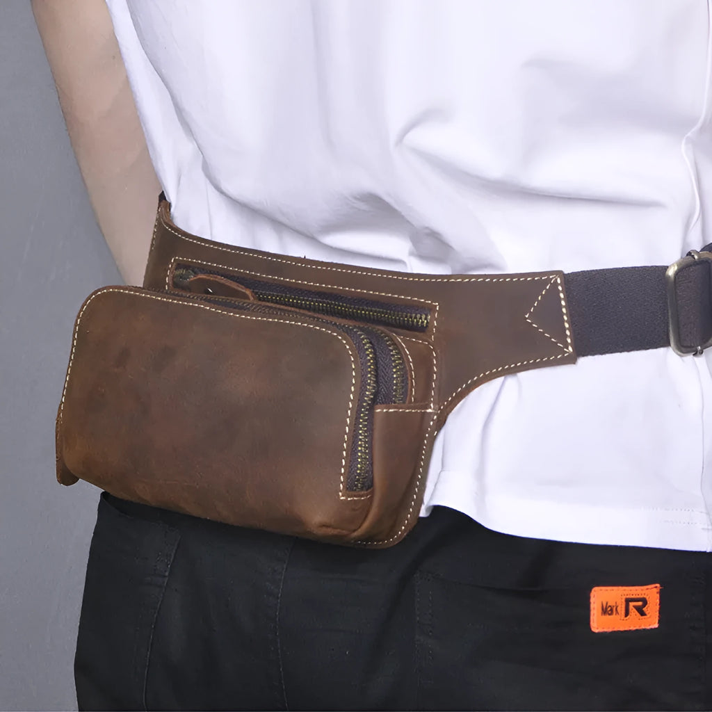 Brown top layer cow leather men's sports waist bag with zip closure.