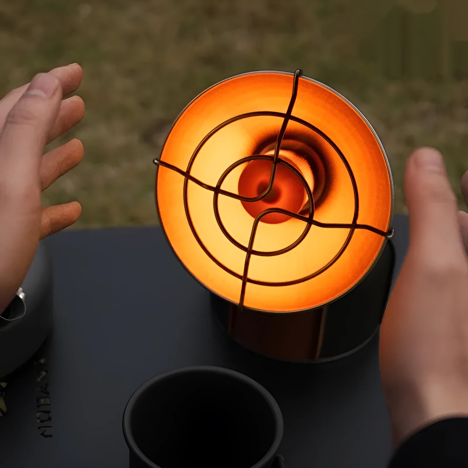 Black and orange portable camping heating stove with automatic ignition, stainless steel construction