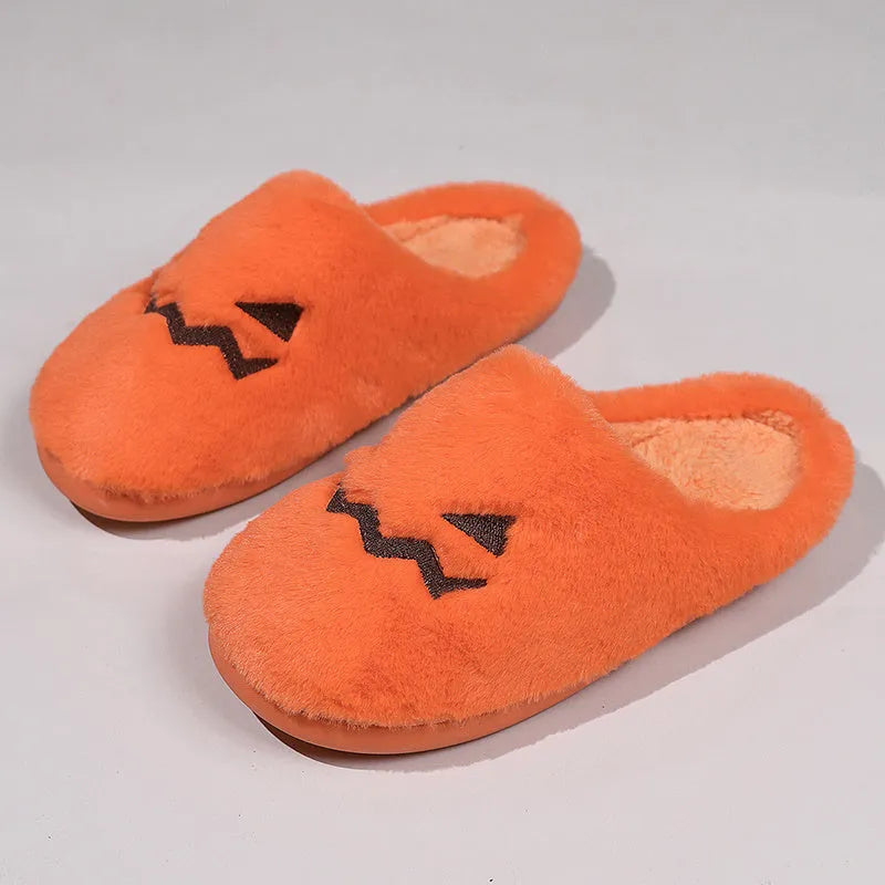 Orange Halloween pumpkin-themed plush slippers with a coral velvet upper and non-slip sole.