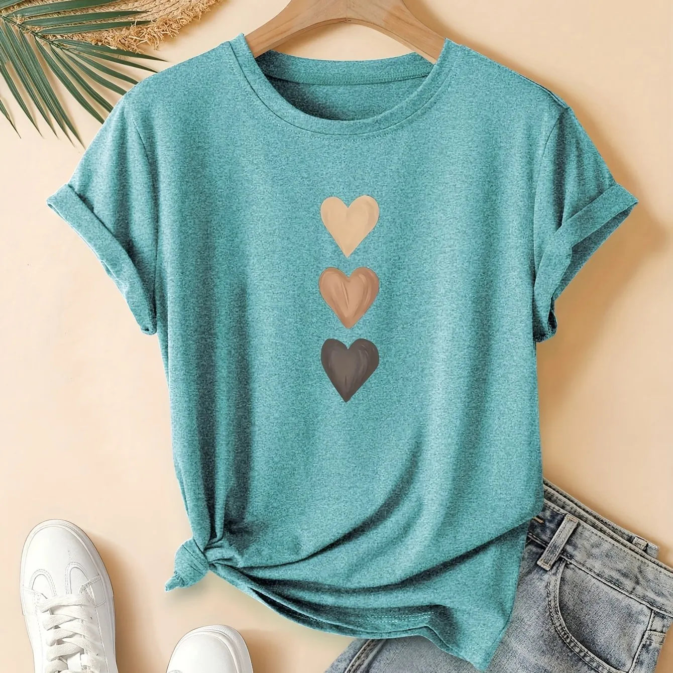Women's printed cotton round neck t-shirt in blue on a hanger, showing art retro short sleeve design.