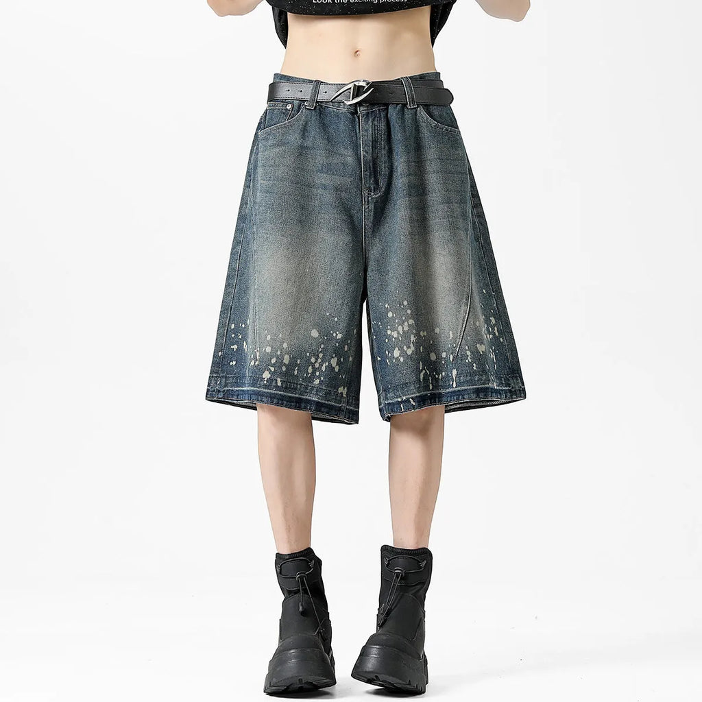 Men's retro blue denim shorts with ripped detailing and splash ink patterns on straight leg cut