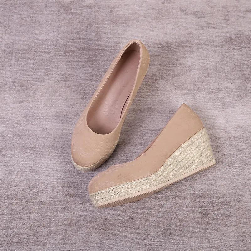 Women's apricot wedge heel pumps with rope detail on heel and round toe.
