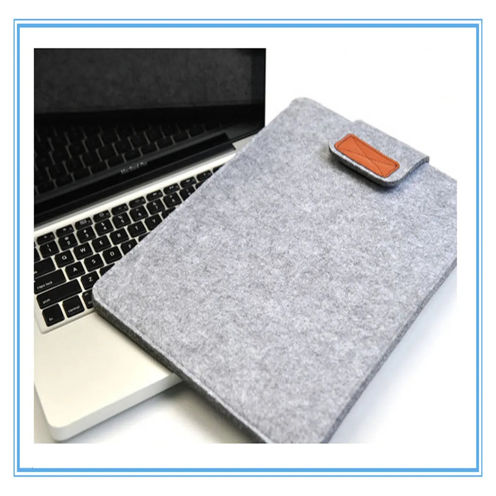 Dark grey felt plush clamshell laptop bag open to show interior with corner protectors