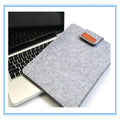Dark grey felt plush clamshell laptop bag open to show interior with corner protectors