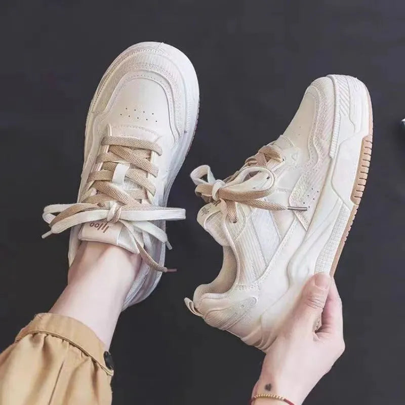Pink and beige low top sneakers with rubber soles and height-increasing design