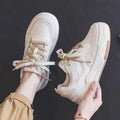 Pink and beige low top sneakers with rubber soles and height-increasing design